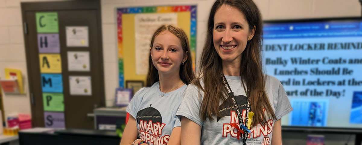 Photo of student and teacher wearing matching Mary Poppins t-shirts