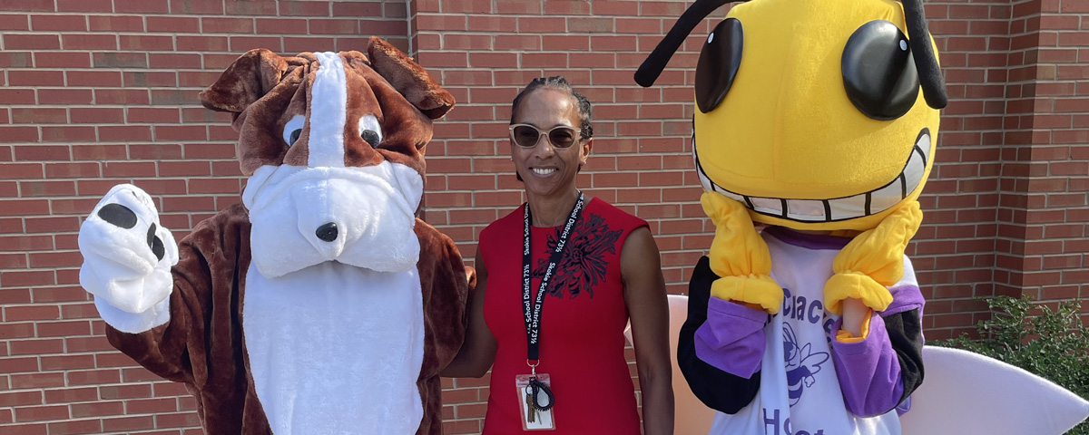 Photo of Superintendent Hightower with Champ the Bulldog and Ollie the Hornet