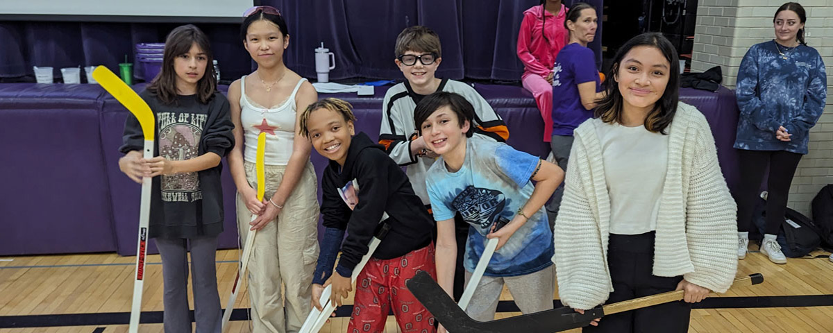 Photo of students ready to play floor hockey