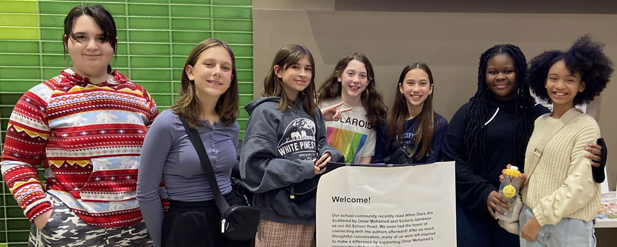 Photo of smiling middle school students standing together