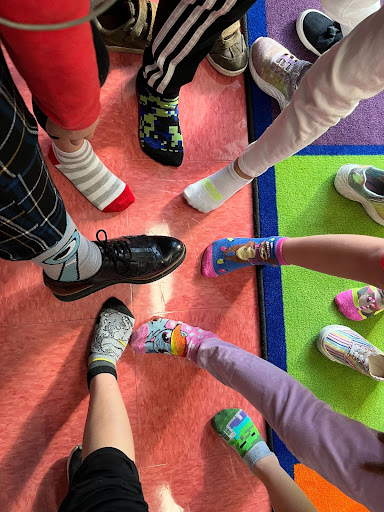 Circle of feet displaying socks